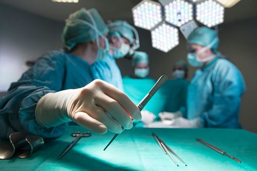 Surgeons in full surgical gear during operation