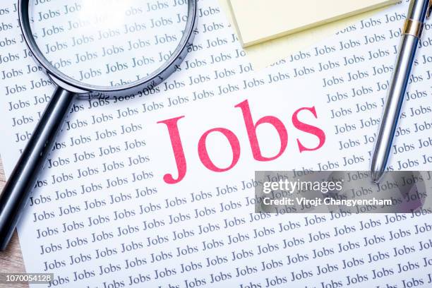 Job Search Concept, hand holding magnifying glass for search jobs.