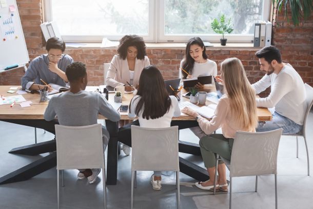 Business meeting of young creative team, office interior