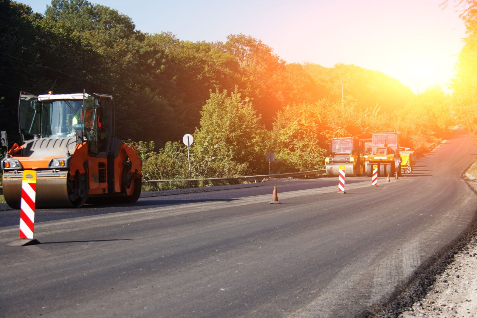 Carrying out repair works: asphalt roller stacking and pressing hot lay of asphalt. Machine repairing road